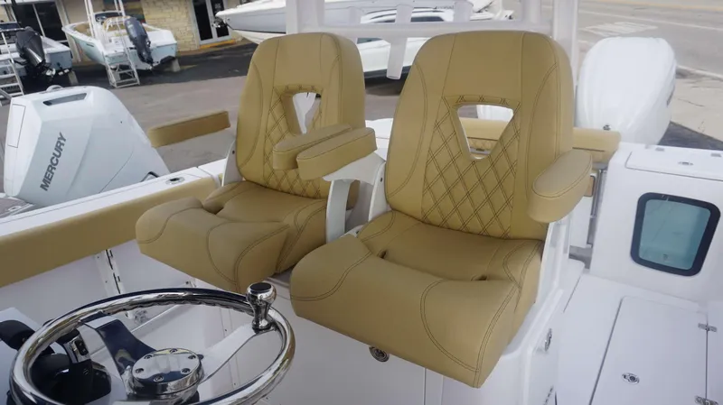 Slide: The Image of Luxury seating on 2025 Sportsman 282 Open boat with Mercury engine in background. - 14