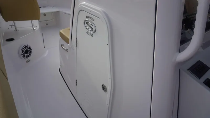 Slide: The Image of 2025 Sportsman 282 Open boat interior with white console and tan seating. - 24