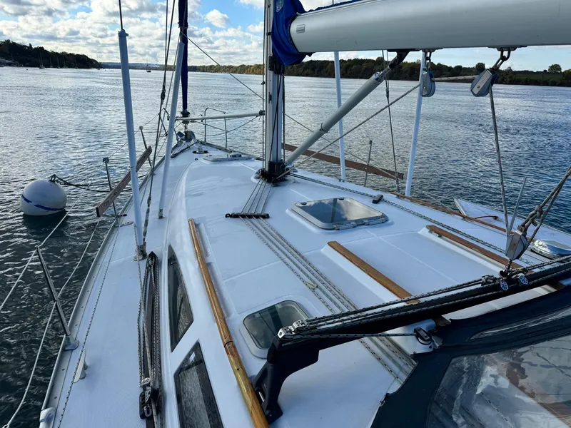 Slide: The Image of Sailing yacht Jeanneau Sun Odyssey 40, 2001 model, on calm waters under a partly cloudy sky. - 10
