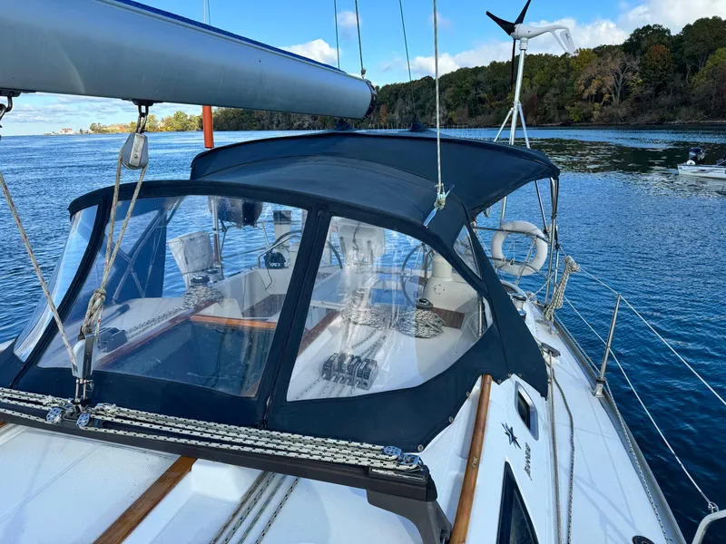 Slide: The Image of 2001 Jeanneau Sun Odyssey 40 sailboat with blue canopy on calm water. - 14