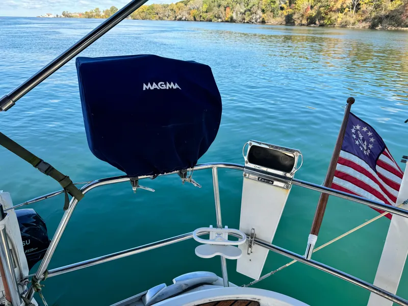 Slide: The Image of Jeanneau Sun Odyssey 40 sailboat, 2001 model, with American flag on calm waters. - 15