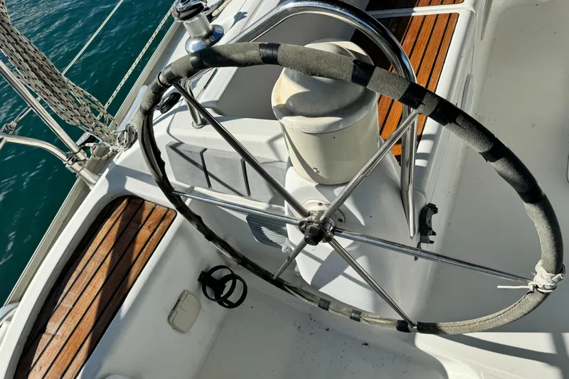 Slide: The Image of Steering wheel of 2001 Jeanneau Sun Odyssey 40 sailboat with wooden deck details. - 16