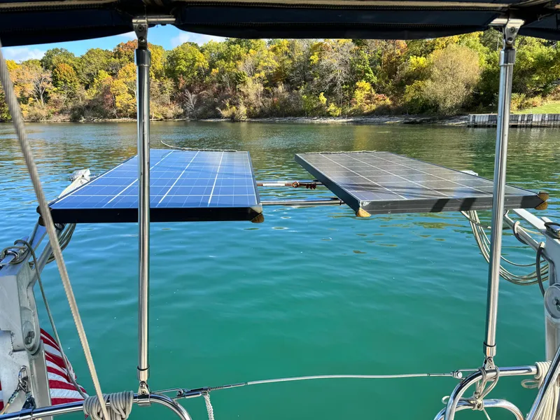 Slide: The Image of Solar panels on Jeanneau Sun Odyssey 40 sailboat, 2001, with scenic water and forest backdrop. - 19