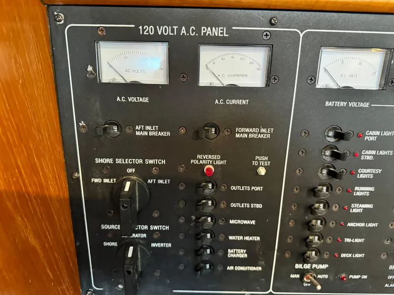 Slide: The Image of 120V AC panel on 2001 Jeanneau Sun Odyssey 40 sailboat, showing voltage and current meters. - 36