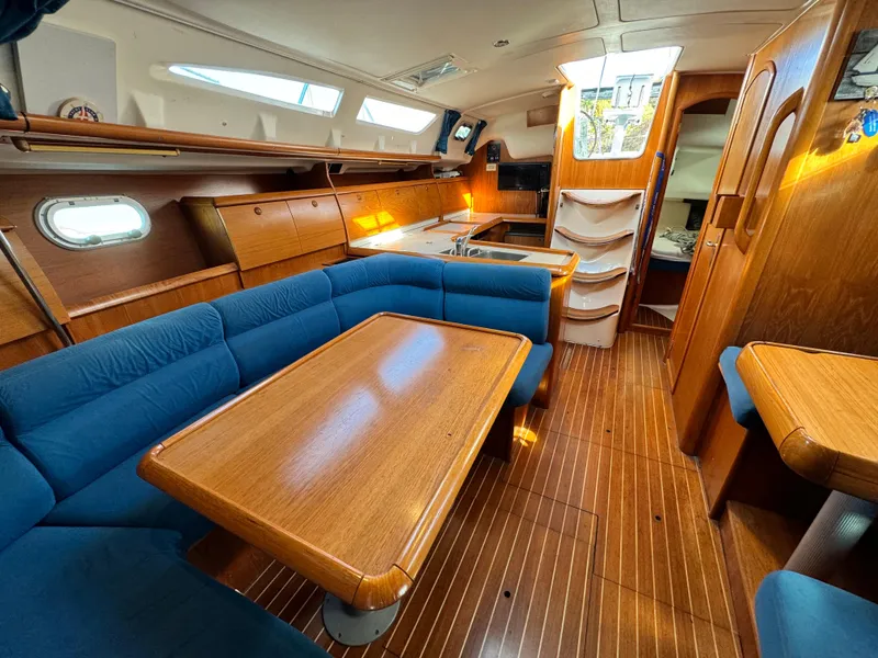 Slide: The Image of Interior of 2001 Jeanneau Sun Odyssey 40 yacht with wooden furnishings and blue seating. - 42