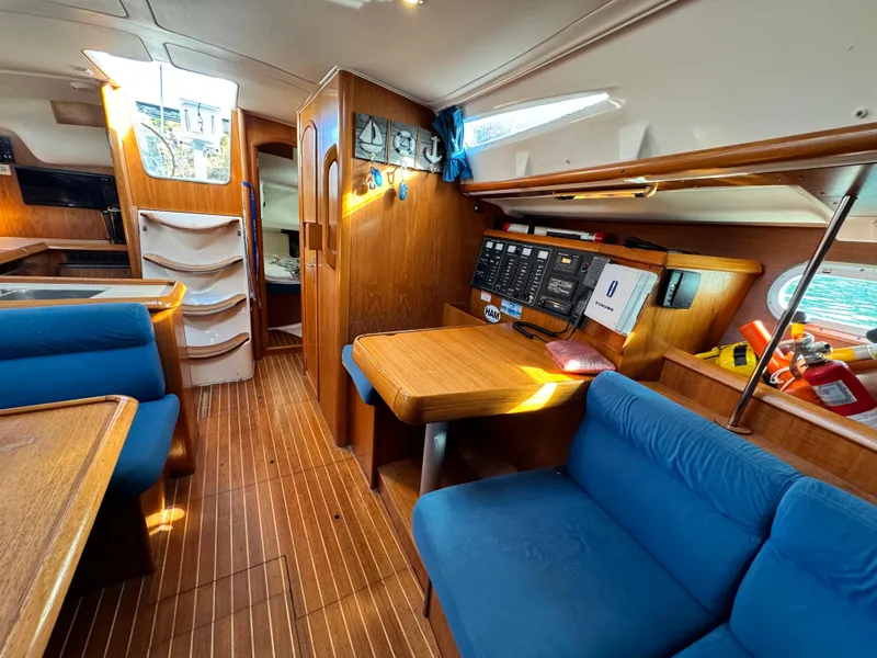 Slide: The Image of Interior of 2001 Jeanneau Sun Odyssey 40 sailboat with wood finish and blue seating. - 43