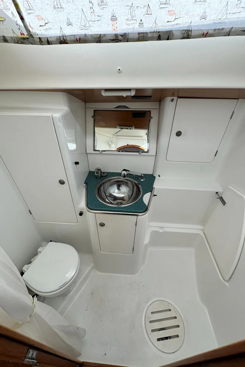 Slide: The Image of 2001 Jeanneau Sun Odyssey 40 bathroom with sink, toilet, and storage cabinets. - 46