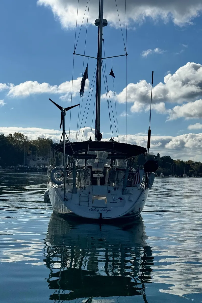 Slide: The Image of 2001 Jeanneau Sun Odyssey 40 sailboat on calm water under a partly cloudy sky. - 6