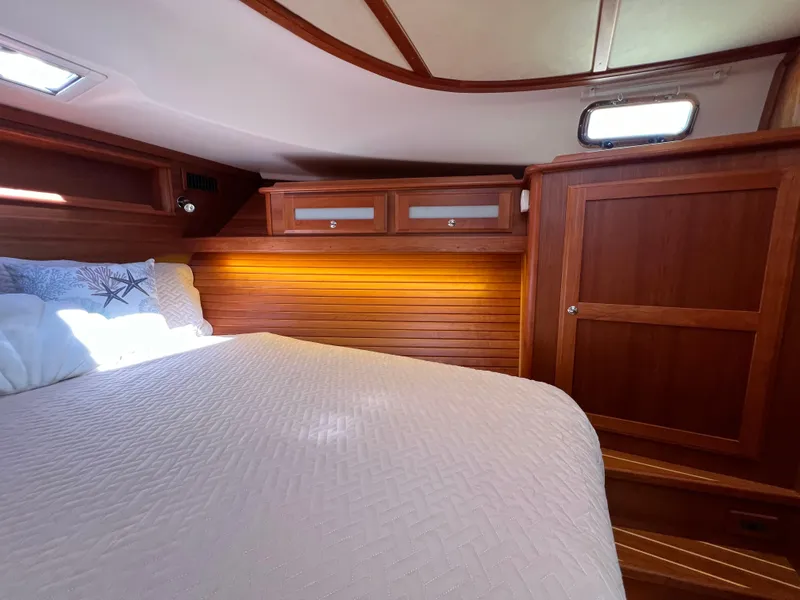 Slide: The Image of Luxurious cabin interior of 2018 Sabre 45 Salon Express yacht with wood paneling and cozy bedding. - 16