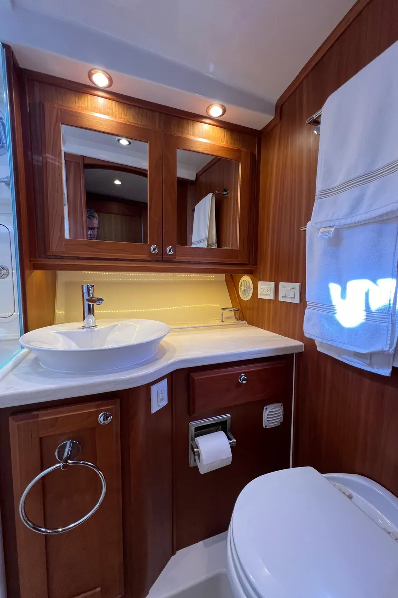 Slide: The Image of Luxurious bathroom in 2018 Sabre 45 Salon Express yacht with wood cabinetry and modern fixtures. - 19