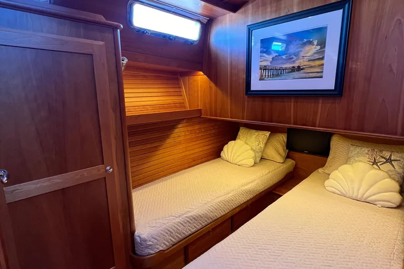 Slide: The Image of 2018 Sabre 45 Salon Express cabin with twin beds and nautical decor. - 23