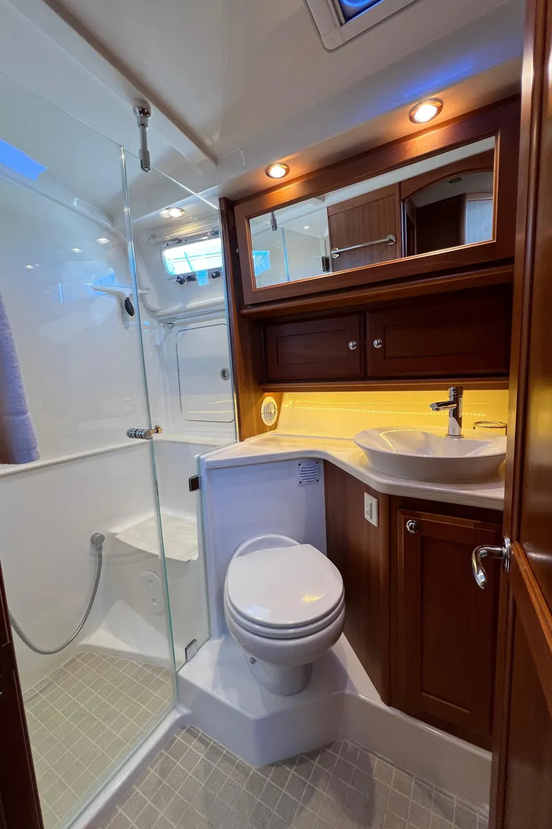 Slide: The Image of Luxurious bathroom in 2018 Sabre 45 Salon Express yacht with modern fixtures and wood accents. - 25