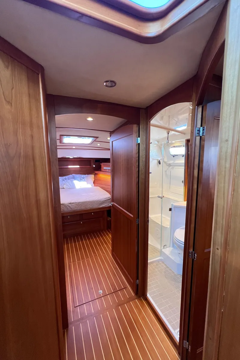 Slide: The Image of Interior of 2018 Sabre 45 Salon Express yacht, featuring wood paneling and a cozy cabin. - 26