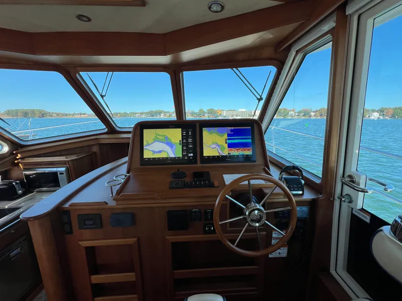 Slide: The Image of 2018 Sabre 45 Salon Express helm with navigation screens and steering wheel. - 28