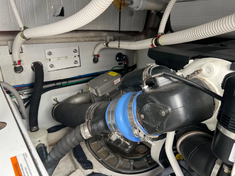 Slide: The Image of Engine room of 2018 Sabre 45 Salon Express with visible hoses and components. - 45