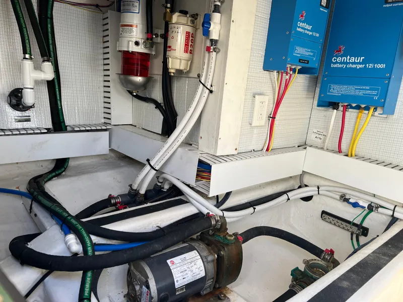 Slide: The Image of Engine room of 2018 Sabre 45 Salon Express with wiring and battery chargers. - 46