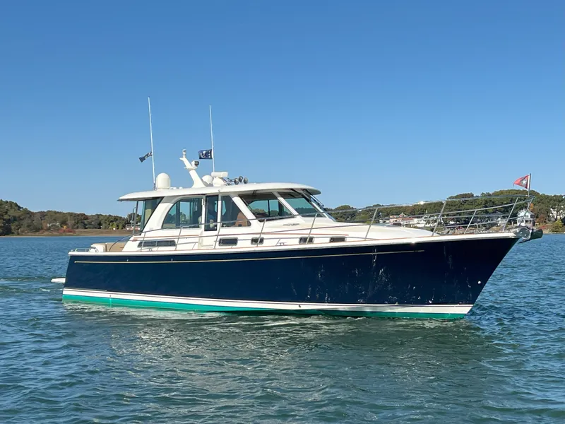 Slide: The Image of 2018 Sabre 45 Salon Express yacht on calm water under clear blue sky. - 9