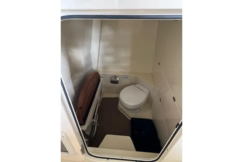 Slide: The Image of 2024 Chris-Craft Catalina 28 boat interior bathroom with toilet and compact design. - 9