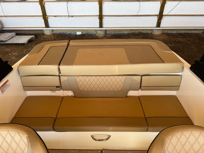 Slide: The Image of 2025 Bayliner VR4 Bowrider I/O interior with tan cushioned seating. - 12