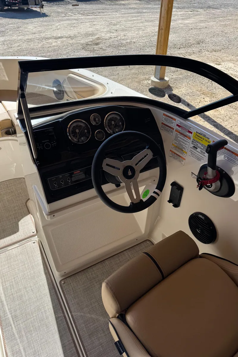 Slide: The Image of 2025 Bayliner VR4 Bowrider I/O cockpit with steering wheel and dashboard controls. - 18