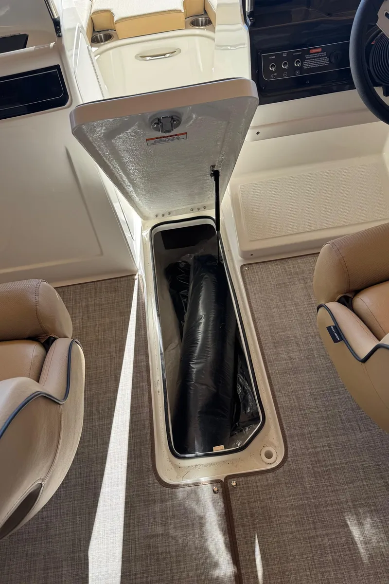 Slide: The Image of 2025 Bayliner VR4 Bowrider I/O interior storage compartment with open hatch. - 19