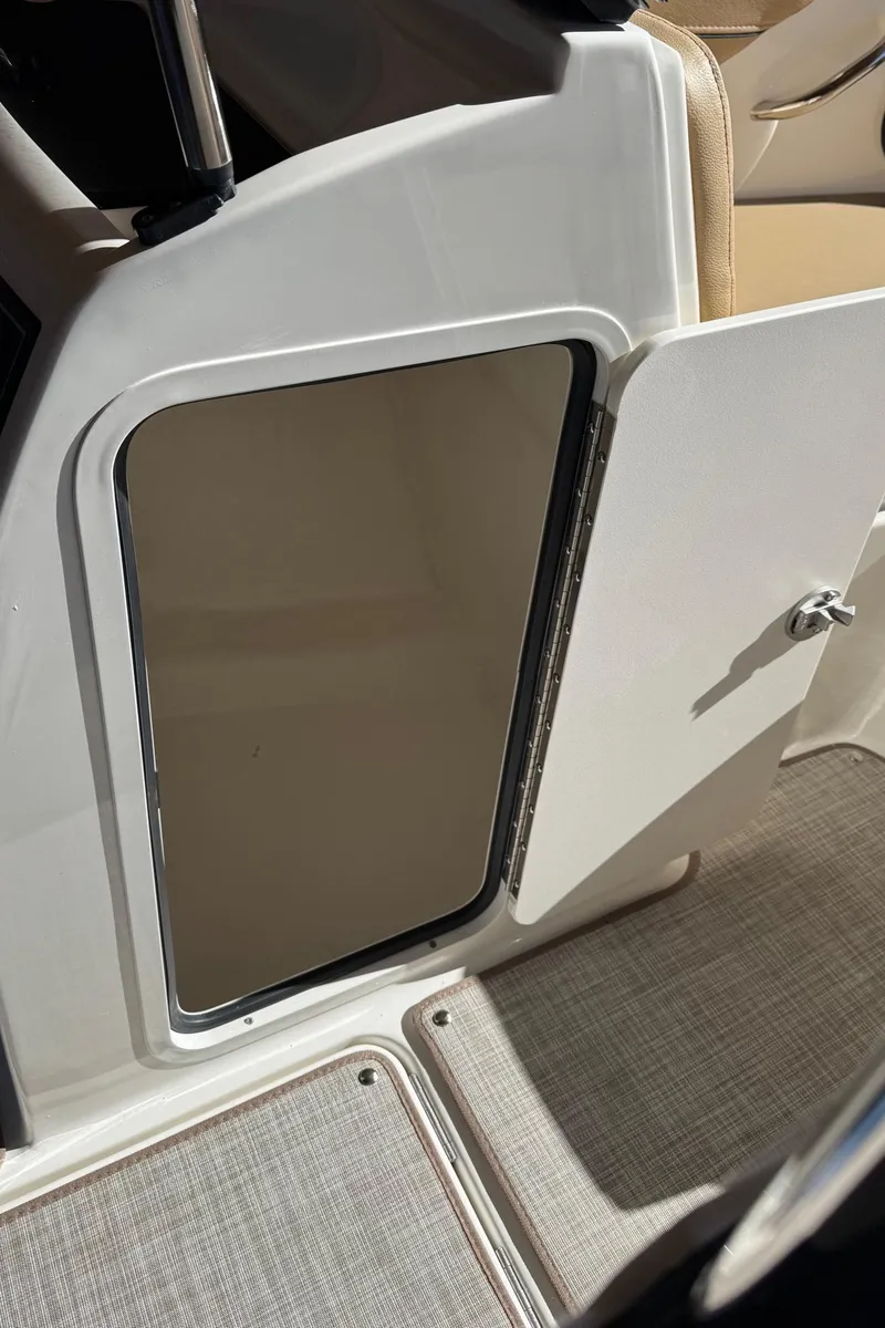 Slide: The Image of 2025 Bayliner VR4 Bowrider I/O interior storage compartment with open door. - 21