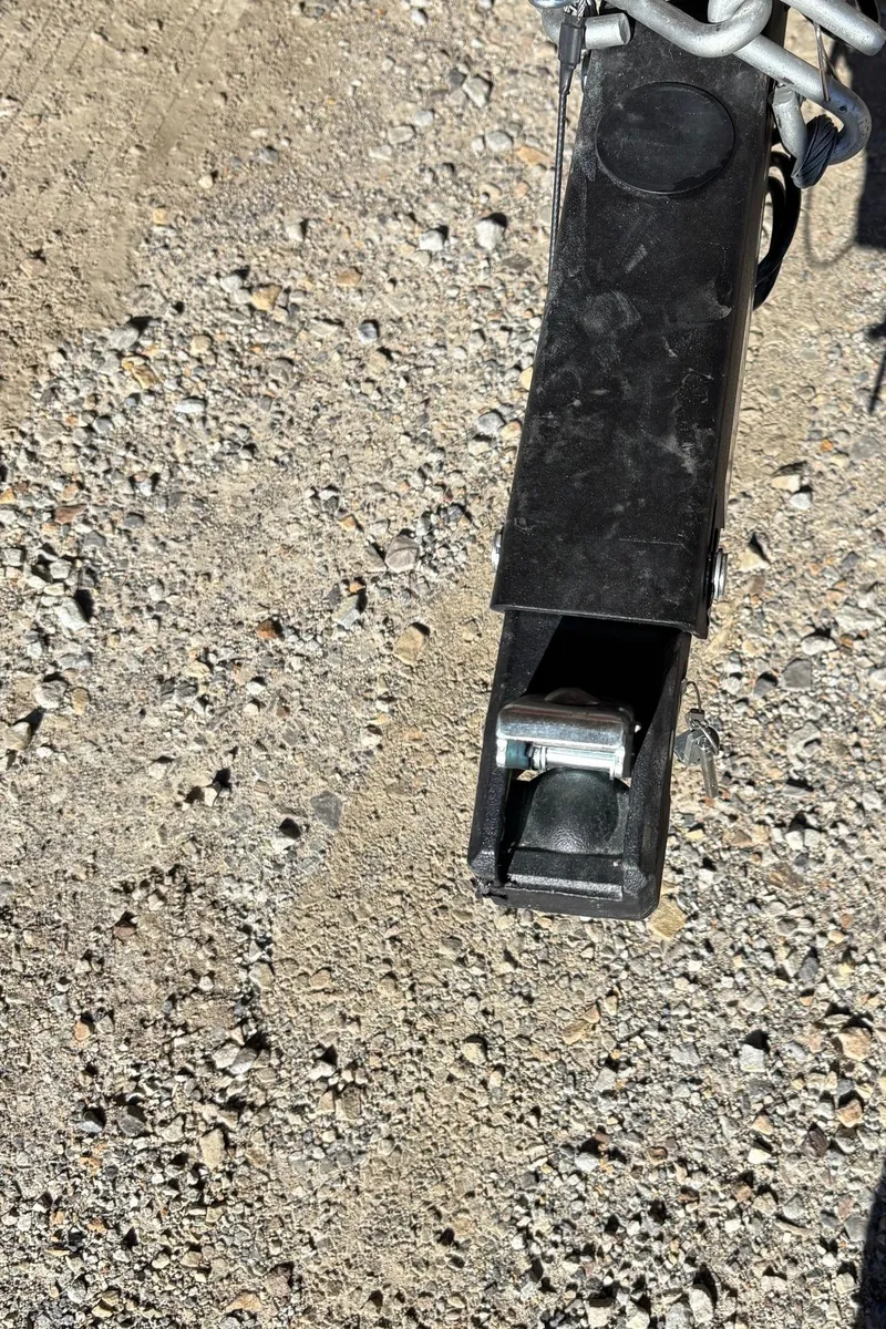 Slide: The Image of Close-up of a 2025 Bayliner VR4 Bowrider I/O trailer hitch on gravel. - 22