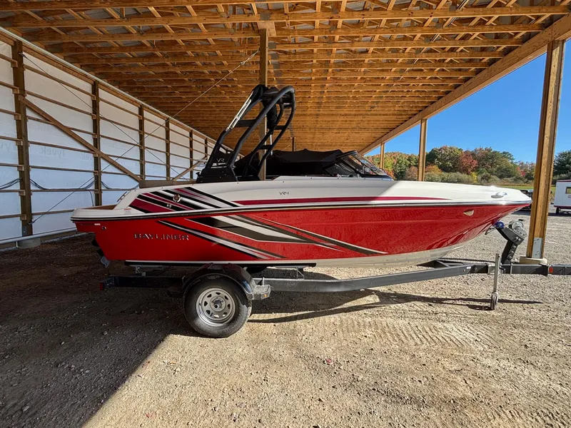 Slide: The Image of 2025 Bayliner VR4 Bowrider I/O boat in a covered storage area. - 3