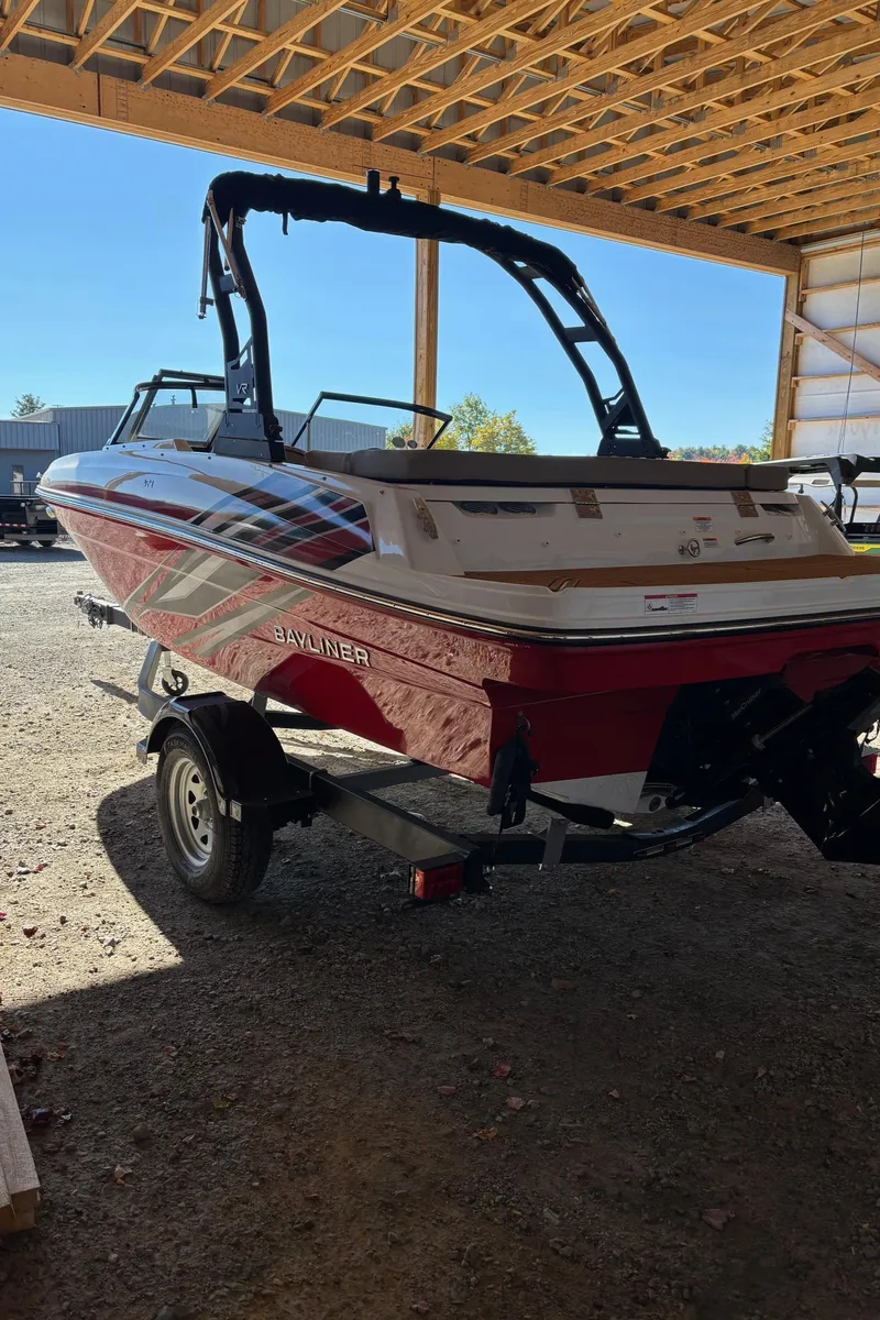 Slide: The Image of 2025 Bayliner VR4 Bowrider I/O boat in a covered storage area. - 5