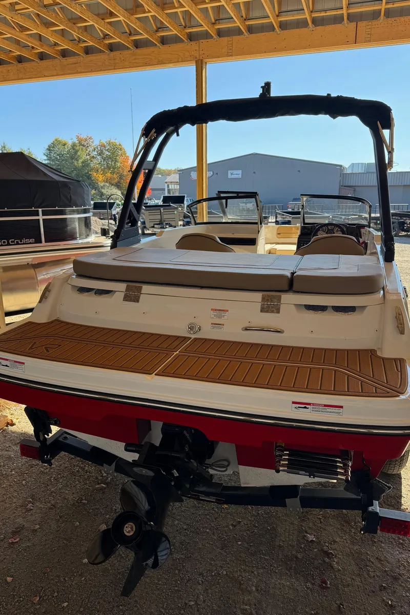 Slide: The Image of 2025 Bayliner VR4 Bowrider I/O boat, rear view, under a covered dock. - 6