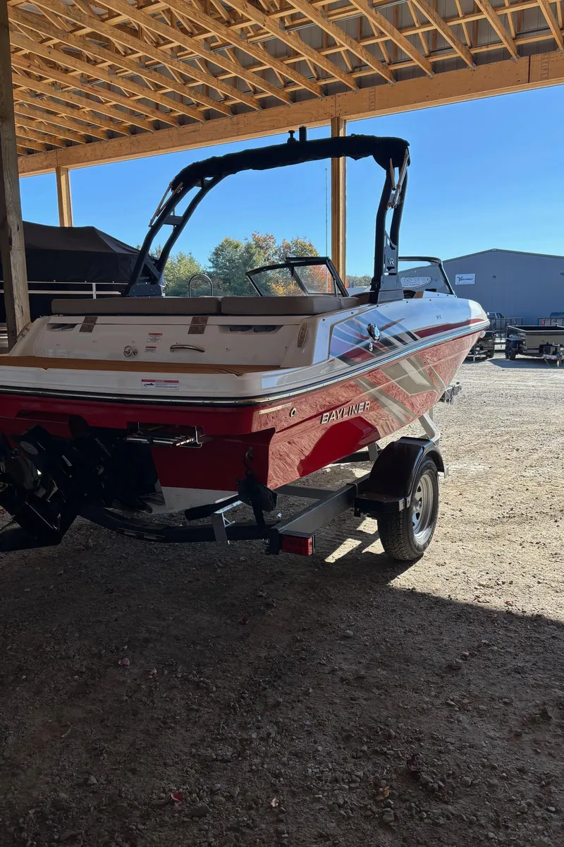 Slide: The Image of 2025 Bayliner VR4 Bowrider I/O boat in a covered storage area. - 7