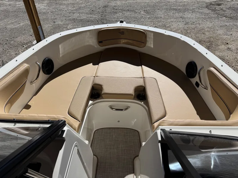 Slide: The Image of 2025 Bayliner VR4 Bowrider I/O interior with beige seating and spacious bow area. - 8