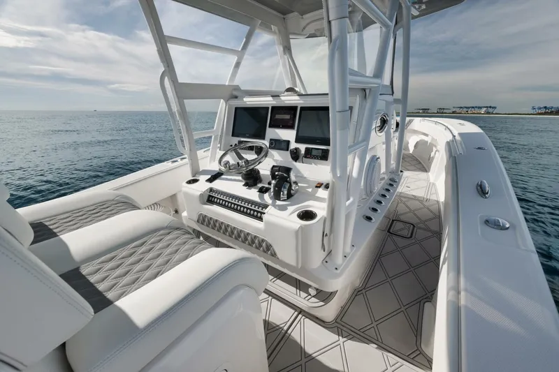 Slide: The Image of 2020 Invincible Open Fisherman boat interior with modern controls and seating on the ocean. - 31