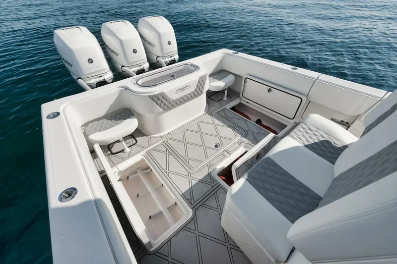 Slide: The Image of 2020 Invincible Open Fisherman boat interior with triple engines, spacious seating, and storage compartments. - 40