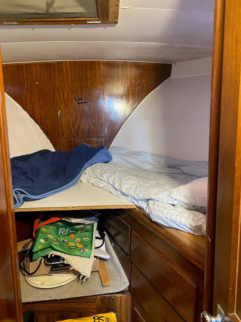 Slide: The Image of Cozy cabin interior of 1968 Hatteras 45 Convertible with wooden furnishings and bedding. - 10