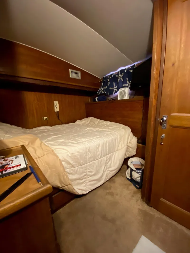 Slide: The Image of Cozy cabin interior of 1968 Hatteras 45 Convertible yacht with wooden furnishings. - 11
