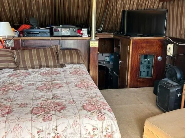 Slide: The Image of Interior of 1968 Hatteras 45 Convertible with bed, electronics, and wood paneling. - 12