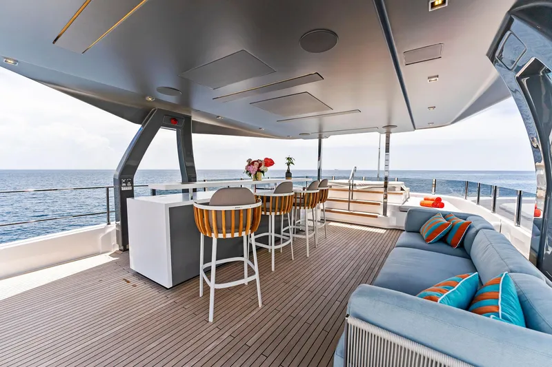 Slide: The Image of Luxurious 2024 Custom Line Navetta 33 yacht deck with seating and ocean view. - 19