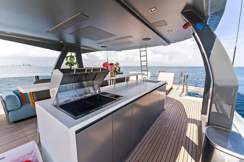 Slide: The Image of Luxurious 2024 Custom Line Navetta 33 yacht deck with modern outdoor kitchen and ocean view. - 23