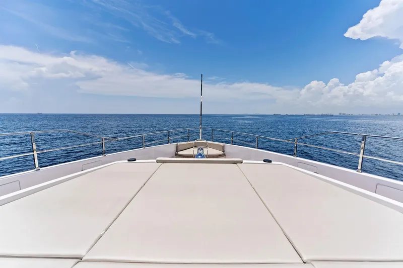 Slide: The Image of Custom Line Navetta 33 yacht deck, 2024 model, cruising on open sea under clear blue sky. - 28