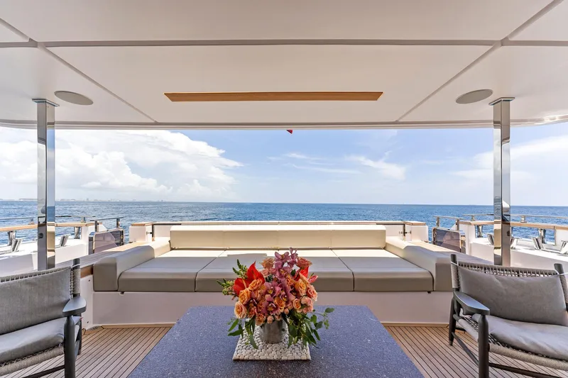 Slide: The Image of Luxurious 2024 Custom Line Navetta 33 yacht deck with ocean view and elegant seating area. - 36