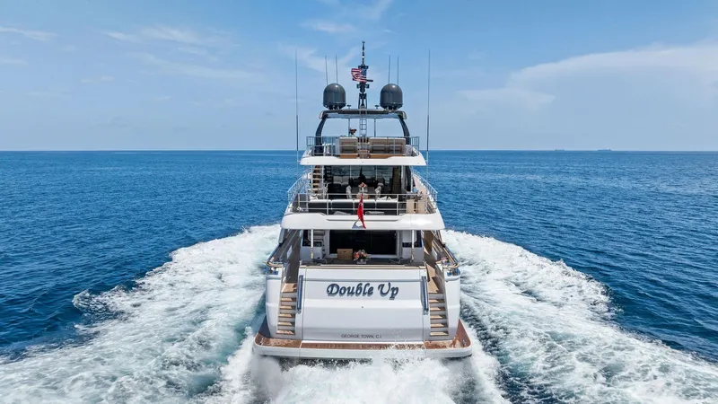 Slide: The Image of 2024 Custom Line Navetta 33 yacht cruising on open sea, rear view. - 8