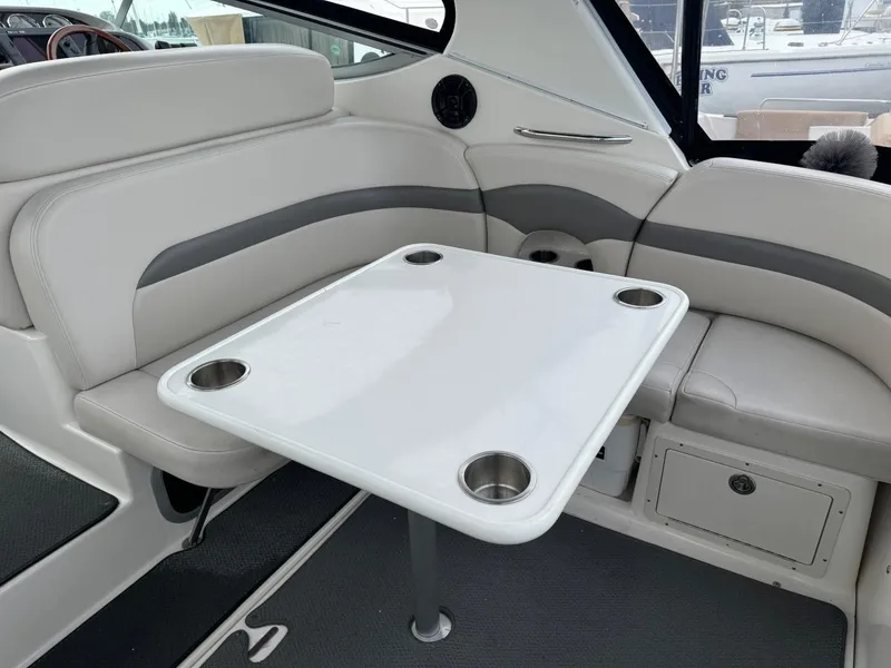 Slide: The Image of Interior of 2005 Chaparral Signature 310 boat with white seating and table. - 10
