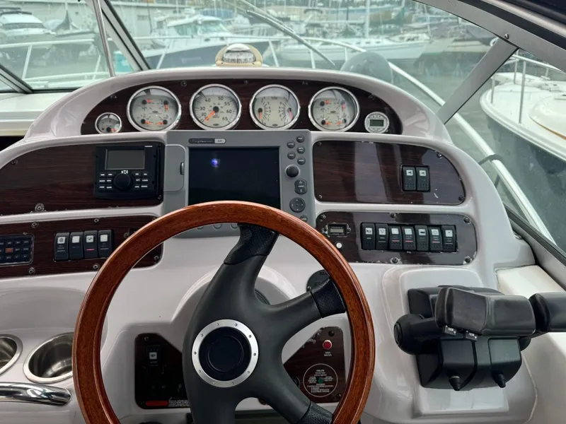 Slide: The Image of 2005 Chaparral Signature 310 boat dashboard with gauges, steering wheel, and control panel. - 15