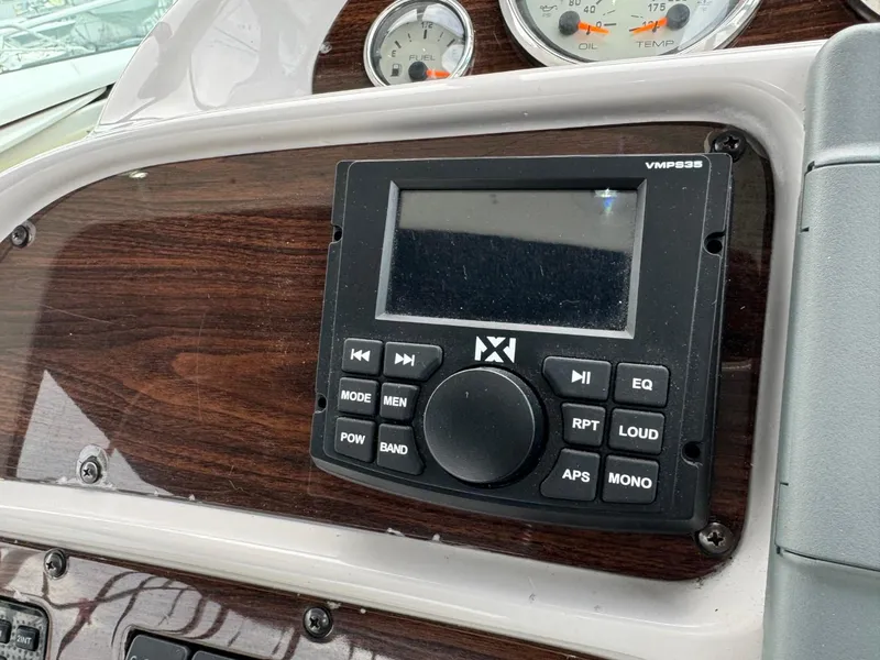 Slide: The Image of Control panel of a 2005 Chaparral Signature 310 boat with audio system and gauges. - 17