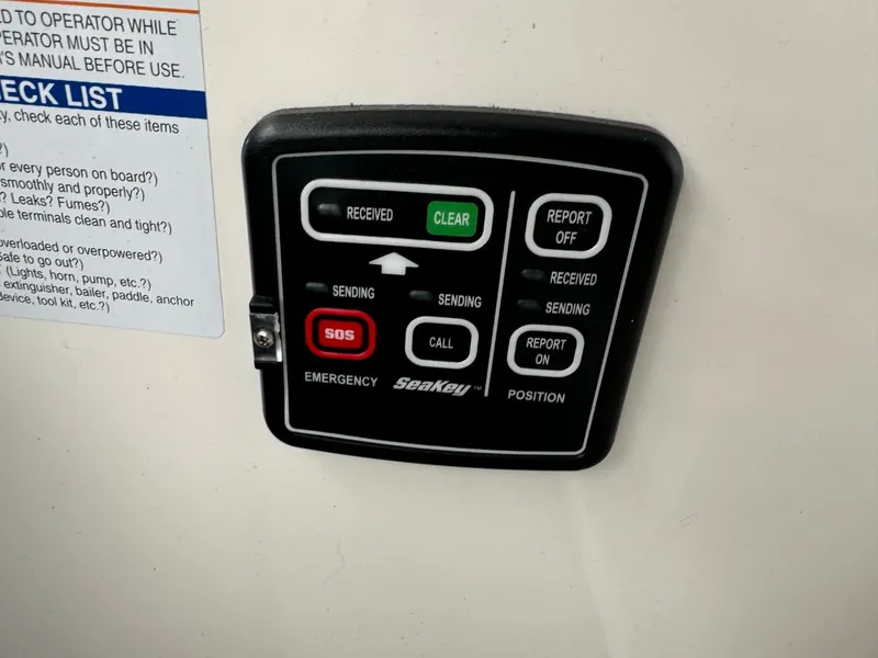 Slide: The Image of Control panel on a 2005 Chaparral Signature 310 boat with emergency and communication buttons. - 18