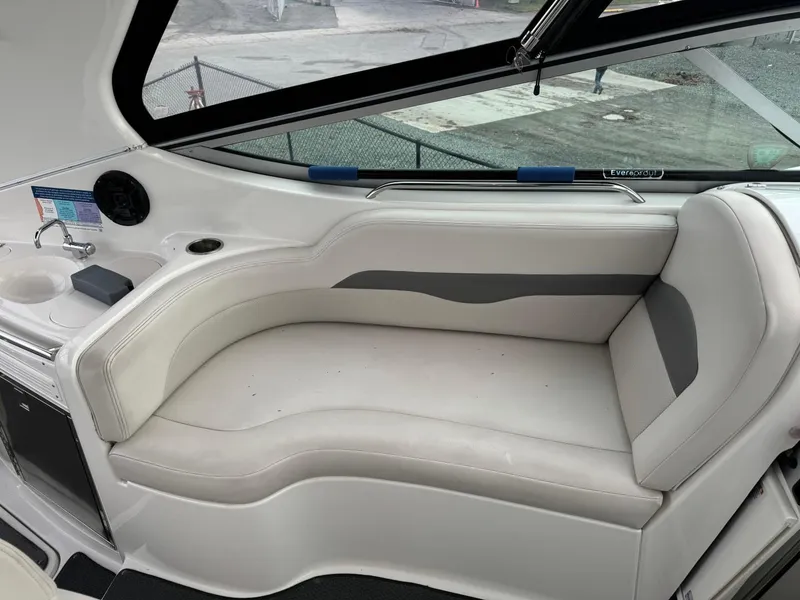 Slide: The Image of 2005 Chaparral Signature 310 boat interior with white seating and compact sink area. - 20