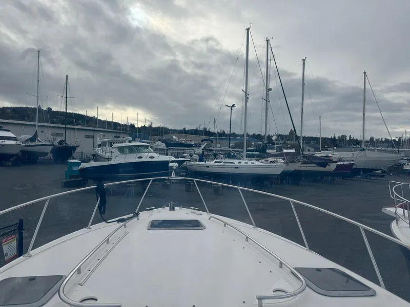 Slide: The Image of 2005 Chaparral Signature 310 in marina with sailboats under cloudy sky. - 21