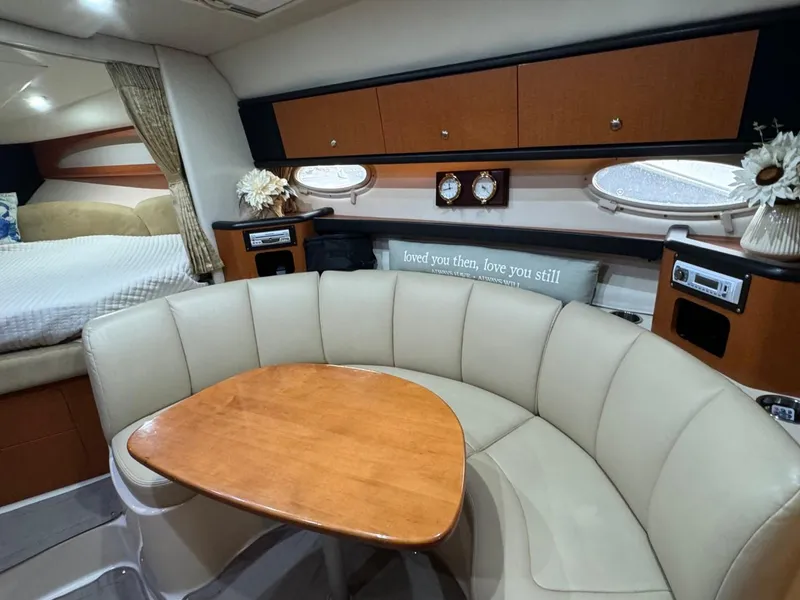 Slide: The Image of 2005 Chaparral Signature 310 interior with cozy seating, wooden table, and elegant decor. - 25