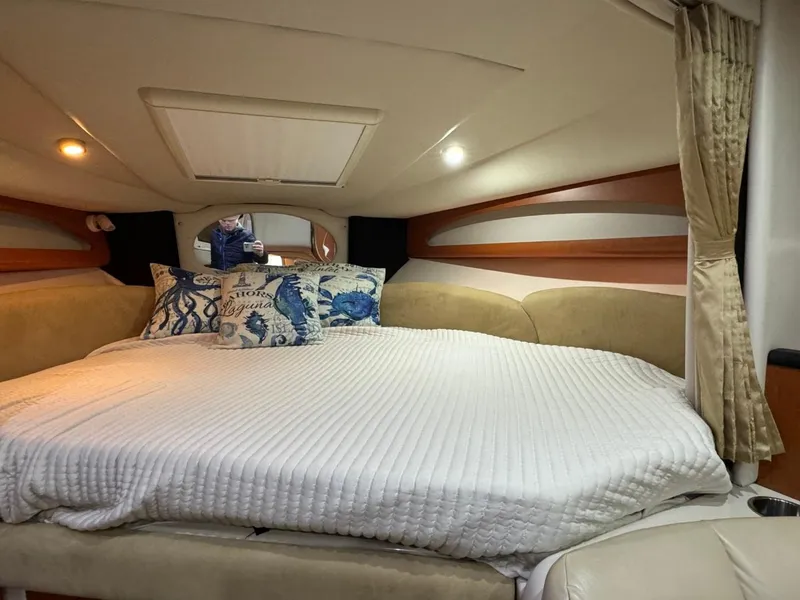 Slide: The Image of Interior cabin of 2005 Chaparral Signature 310 with cozy bed and decorative pillows. - 26